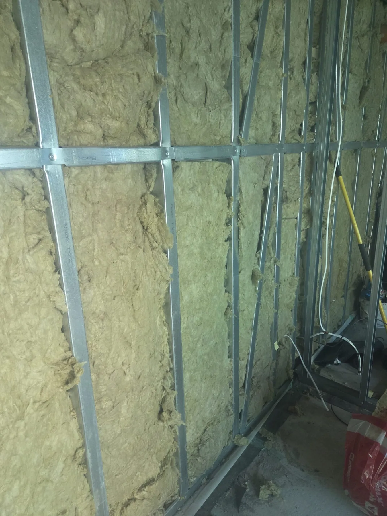 Insulation installed inside the steel-frame garden room