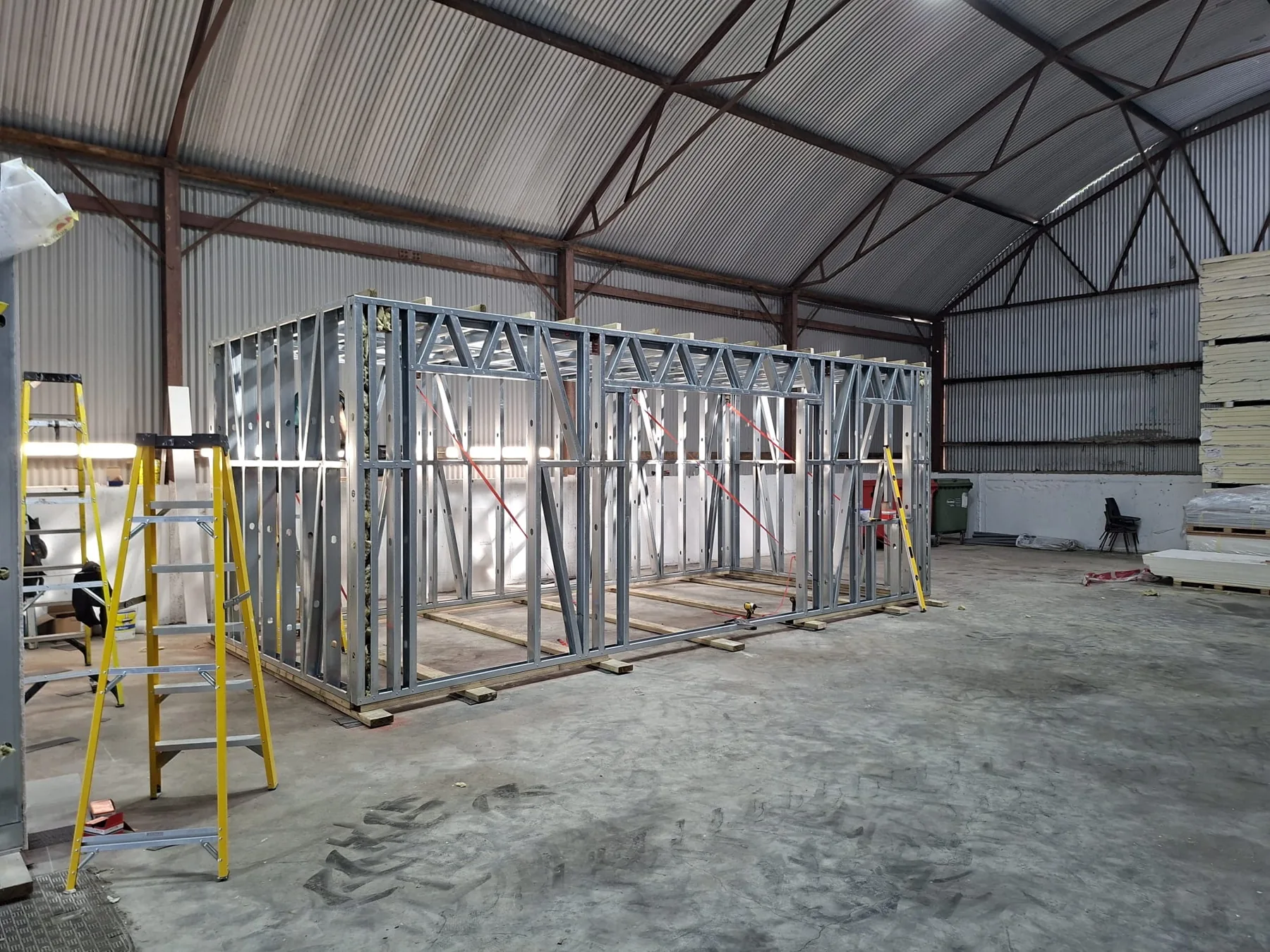 Steel-frame garden room under construction in the workshop